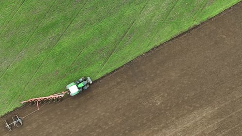 Aerial view of tractor ploughing in Brandenburg, Germany.