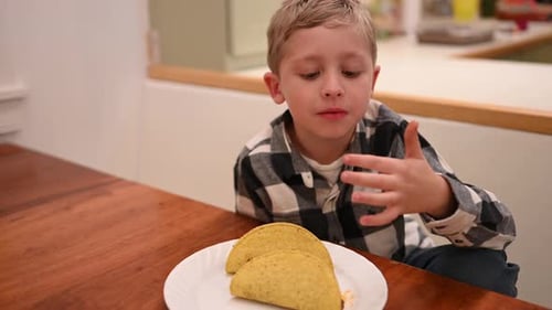 Child Eating Tacos at the Table