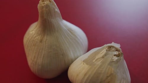 Tilting Close Up of Garlic on a Cutting Board