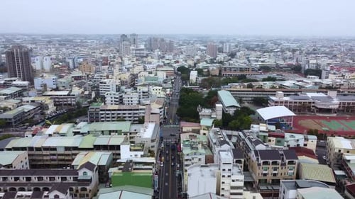 A dense urban area with mixed residential and commercial buildings, aerial view
