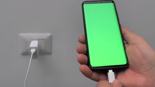 Hand Charging Smartphone Device with Green Screen