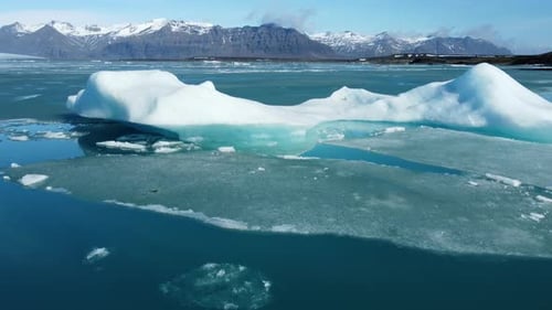 Iceberg From Melting Glacier in Iceland Ancient Blue Ice Floating in Ocean Water Pure Turquoise