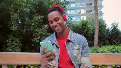 Young Adult Using Smartphone in Urban Park