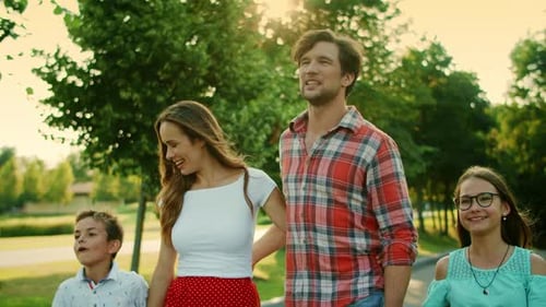 Closeup Smiling Children and Parents Walking in Summer Park. Portrait of Father