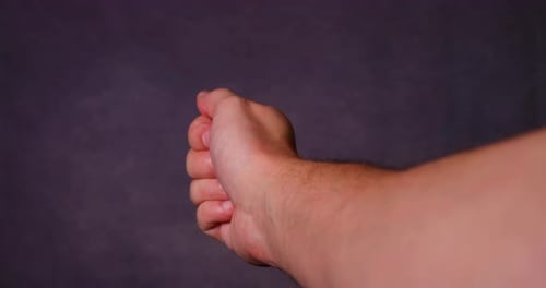 Hand Gesturing Thumbs Up for Approval