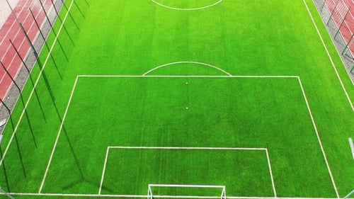 Green football pitch outdoors. Sport stadium for playing team game.