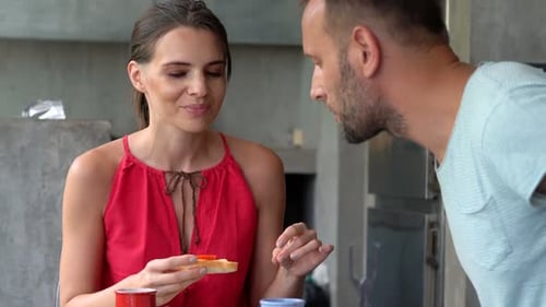 Couple Eating Breakfast Together in Modern Kitchen