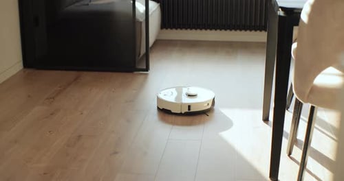 Robot Vacuum Cleans Hardwood Floor in Modern Home