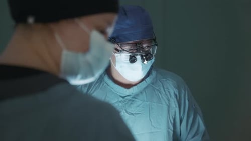 Two surgeon doctors during a procedure in the operating room