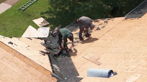 Element of Roofers Installing a New Roof on an Building Drone View