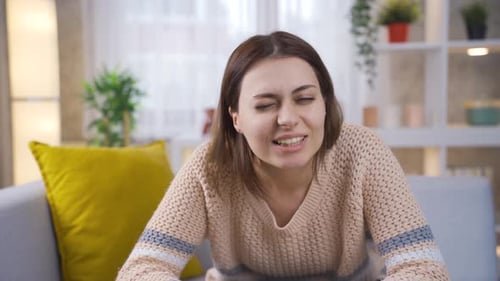 Smiling Woman Talking to Camera While Sitting on Couch