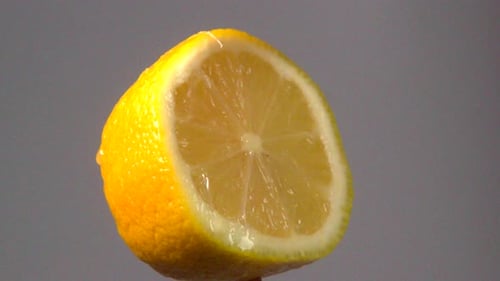 Lemon slice falling onto lemon