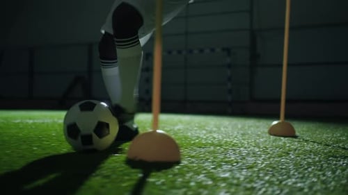 Footballer Practicing Dribbling Tricks in Stadium at Night Closeup View of Feet Kicking Ball