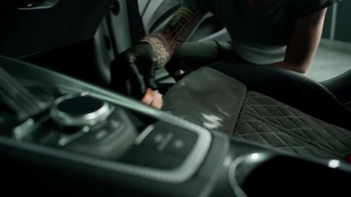 Young Adult Detailing Car Leather with Soft Brush