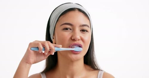 Face, brushing teeth and woman in studio, health and dental hygiene on white background