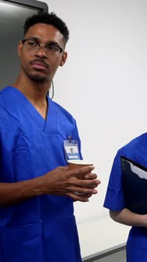 Diverse medical team discussing patient case during hospital briefing