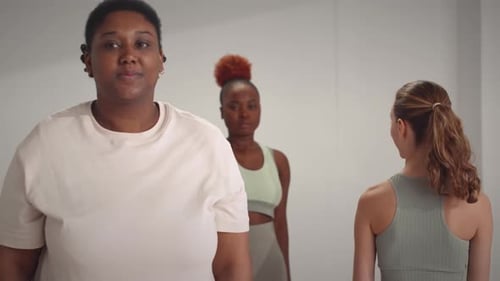 Women Exercising with Dumbbells at Home