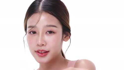 Close up portrait beautiful young Asian woman with healthy facial skin over white background.