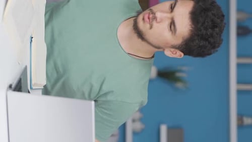 Focused Student Studies Using Book and Laptop