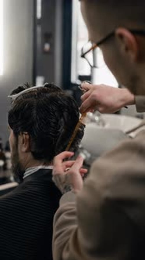 Barber Giving Haircut in Barbershop, Close Up Portrait
