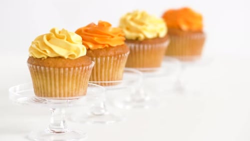 Tasty Cupcakes with Yellow and Orange Frosting