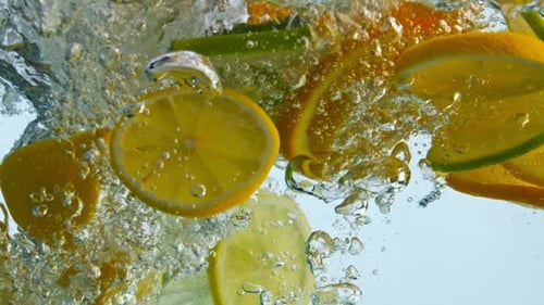 Citrus Slices Plunging into Refreshing Water