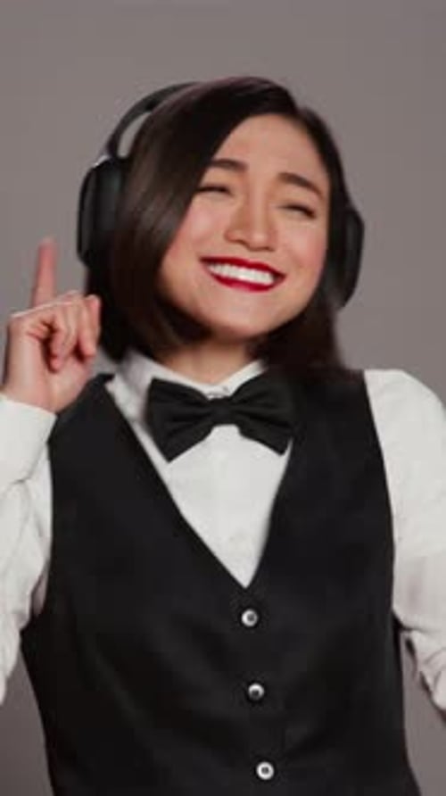 Vertical Video Front Desk Staff Dancing Around in Studio and Listening to Music