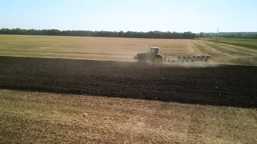 Tractors plowing the field in Ukraine