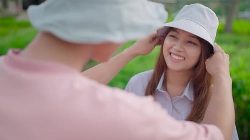 Close-up shots of lovers holding their hats, showing their love to each other and doing various acti