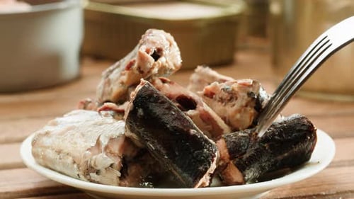 Close Up of Canned Fish Being Pierced