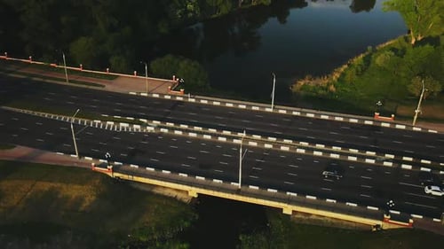 City Highway. Overpass Across The River. There Is Active Traffic On The Road.