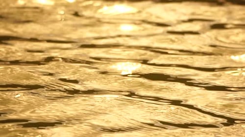 Sun Reflecting on Sparkling Sea Lake Water Surface Ocean at Sunset Sunrise Sunrays Flickering in
