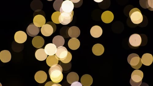 Defocused Gold Bokeh Lights on Black Background
