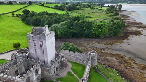 Beautiful aerial reveal of Doe Castle building in Donegal, Ireland. Moody afternoon.
