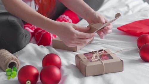 Woman Assembling Christmas Gift Boxes at Home