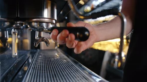 Barista Makes Coffee in a Coffee Machine in a Restaurant