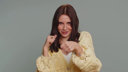Playful Young Woman Boxing in Studio