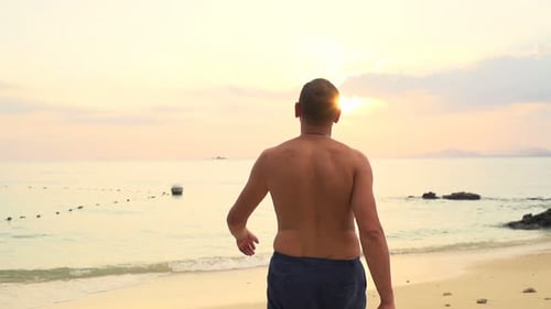 Young Man Walking on Beach 30s