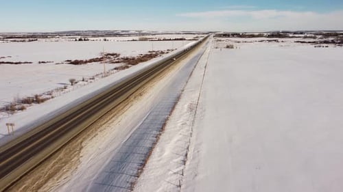 Autos fahren an sonnigen Wintertagen auf der Autobahn in Alberta. Drohnenschuss.
