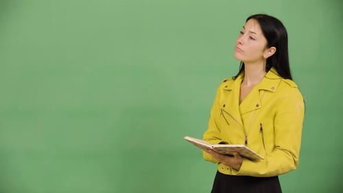 A Young Beautiful Caucasian Woman Reads a Book Green Screen Studio