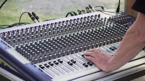 Sound mixer and hands at live concert, slowmo closeup