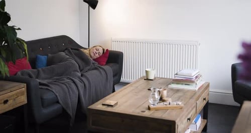 Woman Relaxing on Couch Indoors During Daytime