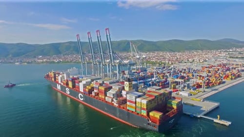 A container-loaded ship approaching the port