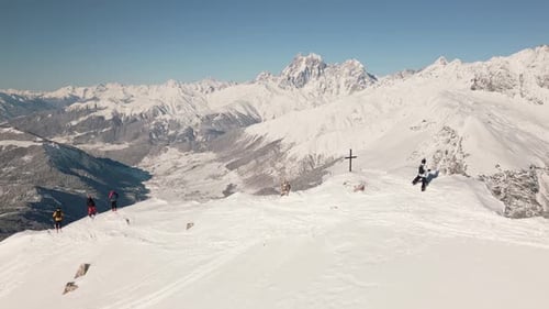 Skiers on Snowy Mountain Top in Winter