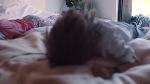 Two Children Playing on Bed Together Indoors Daytime