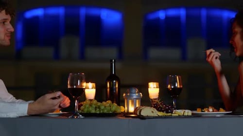 Romantic Evening: Couple Enjoying Intimate Candlelit Dinner