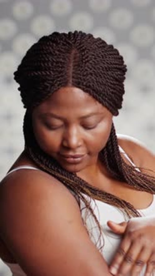 Woman Caresses Arm and Shoulder in Tank Top