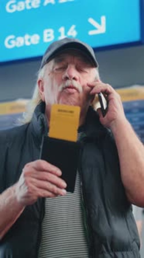 Crowded Airport Terminal Elderly Man Holding Plane Ticket Talking By Mobile Phone