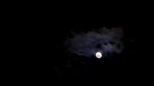 Moon Drifting Through Clouds at Night