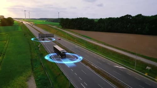 Aerial view of modern autonomous trucks scanning their surroundings with sensors. Self-driving cars.